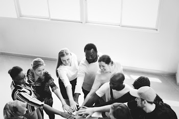 Grayscale Photography of People Doing Team Hand Cheers