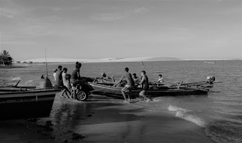 Grayscale Photography of People Pulling Boat on Shore