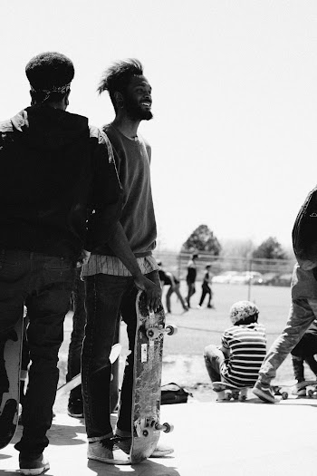 Grayscale Photography of People Standing and Sitting