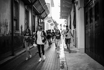 Grayscale Photography Of People Walking Between Buildings