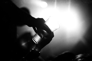 grayscale photography of person holding drinking glass