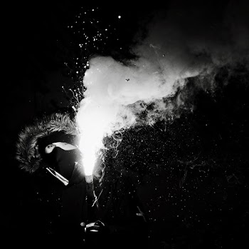 Grayscale Photography of Person Holding Flare