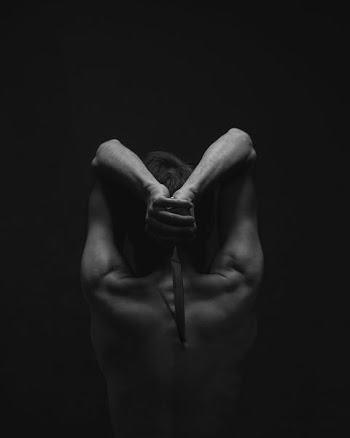 grayscale photography of person holding knife
