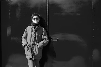 Grayscale Photography of Person Learning on Wall