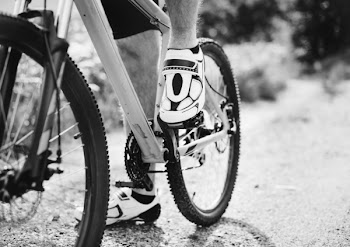 Grayscale Photography of Person Riding Bicycle