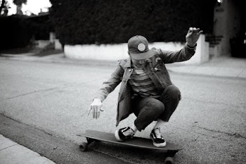 grayscale photography of person riding on longboard