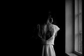 Grayscale Photography of Person Standing Beside Window
