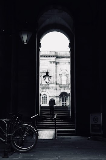 Grayscale Photography Of Person Walking On Stairs