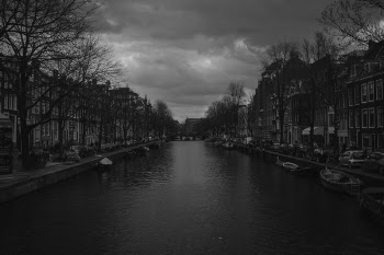 Grayscale Photography of River Near Buildings