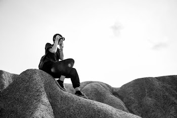 grayscale photography of sitting woman taking photo