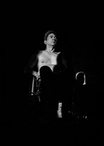 Grayscale Photography of Topless Man Sitting