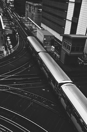 Grayscale Photography Of Train Beside Building