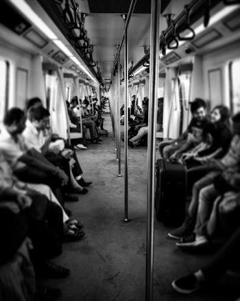 Grayscale Photography of Train Passengers