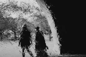 Grayscale Photography of Two Persons Walking Towards the Trees