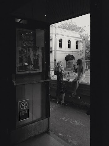 Grayscale Photography of Two Women Near Bar