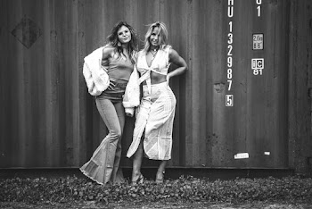 Grayscale Photography of Two Women Standing Near Intermodal Container