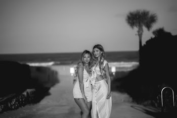 Grayscale Photography of Two Women Standing on Street