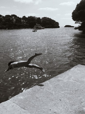 Grayscale Photography Of Woman Diving Into Water