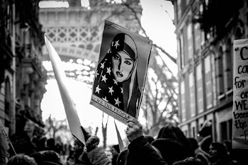 grayscale photography of woman face poster wave on air by people near Eiffel Tower