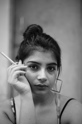 Grayscale Photography of Woman Holding Cigarette