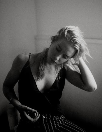 grayscale photography of woman holding her hair