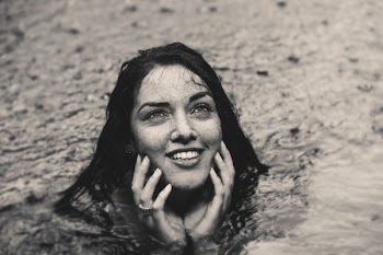 grayscale photography of woman in body of water