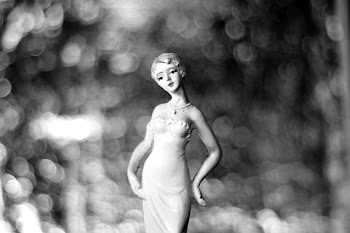 Grayscale Photography of Woman in Dress Figurine