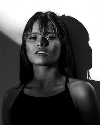 Grayscale Photography Of Woman In Spaghetti Strap Top Leaning On Wall