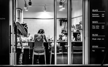 grayscale photography of woman inside cafe