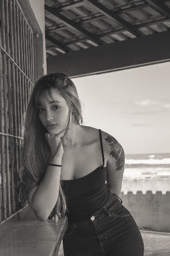 Grayscale Photography of Woman Leaning on Gray Surface
