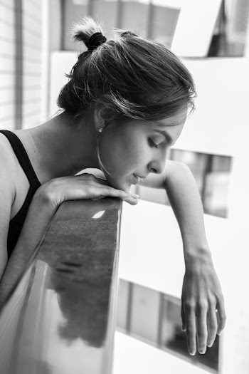 Grayscale Photography of Woman Leaning on Handrail