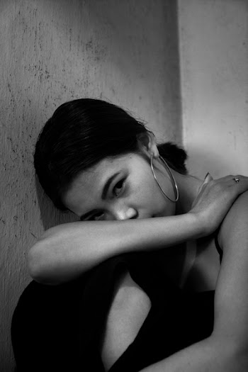 Grayscale Photography of Woman Resting Face on Knee