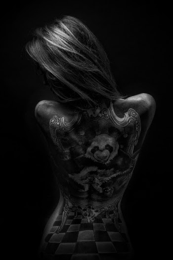 Grayscale Photography of Woman Showing Back Tattoo