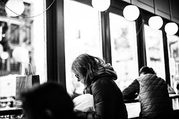 grayscale photography of woman sitting beside man