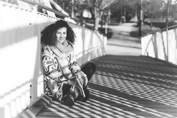 Grayscale Photography of Woman Sitting on Bridge