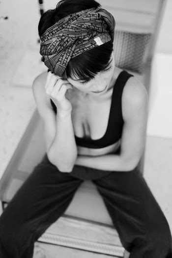 grayscale photography of woman sitting on chair