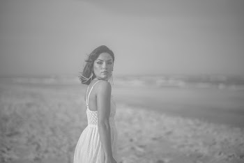 Grayscale Photography of Woman Standing by the Seashore