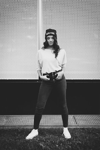 Grayscale Photography of Woman Standing in Front of Building