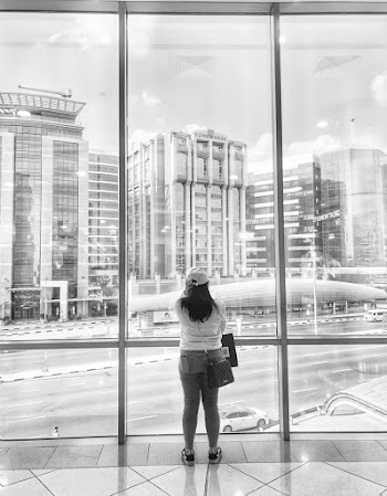 Grayscale Photography of Woman Standing in Front of Mirror