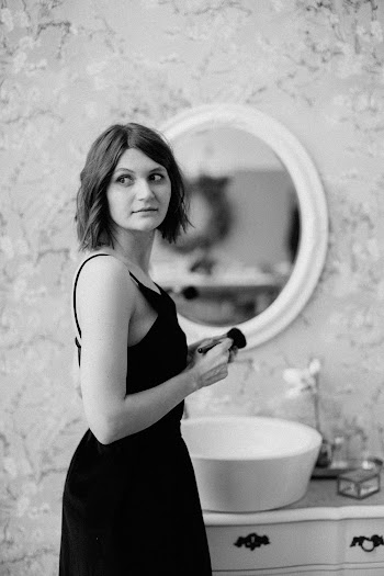Grayscale Photography of Woman Standing Indoors