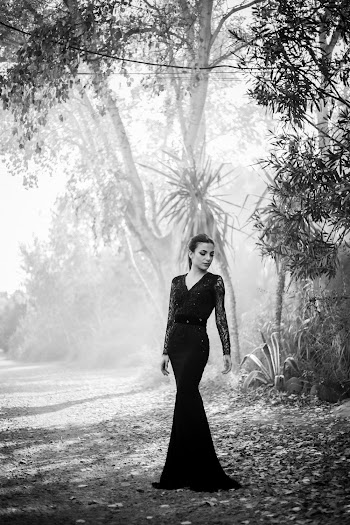 Grayscale Photography Of Woman Standing Near Tall Trees