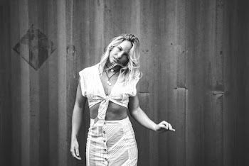 Grayscale Photography of Woman Standing Near Wall