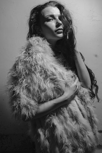 Grayscale Photography of Woman Standing Wearing Fur Coat