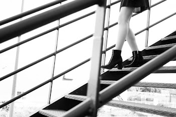 Grayscale Photography of Woman Walking on Stairs