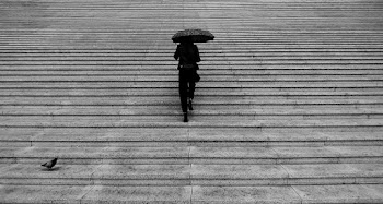 Grayscale Photography of Woman Walking Upstairs