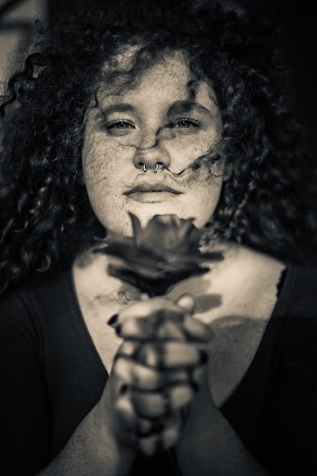 Grayscale Portrait Photo of Woman With Freckles Holding Flower