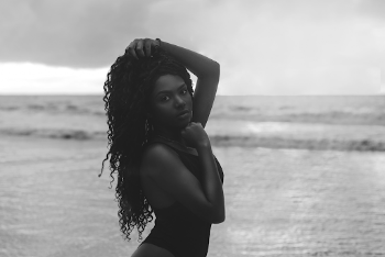 Grayscale Side View Photo of Beautiful Woman in Bikini Posing While Holding Her Hair