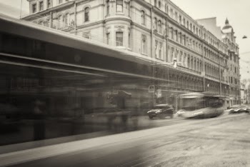 Grayscale View of City With Vehicles Passing Through