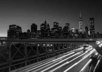 grayscaled photo of timeplased bridge