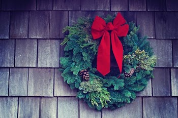 green and red Christmas wreath mounted on wall